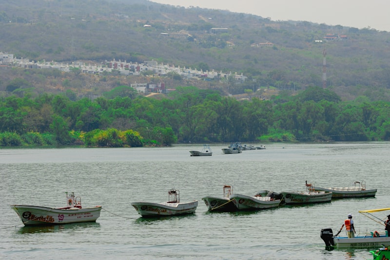 a group of boats floating on top of a lake