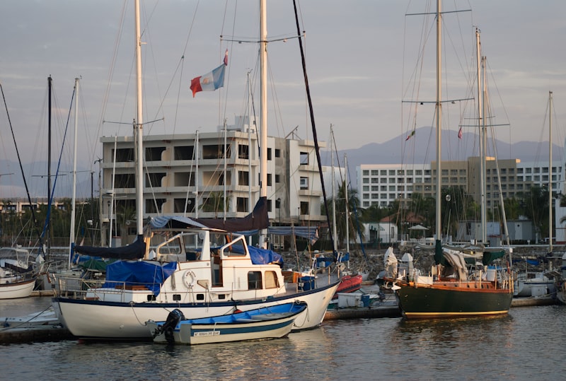 A harbor filled with lots of boats next to a tall building